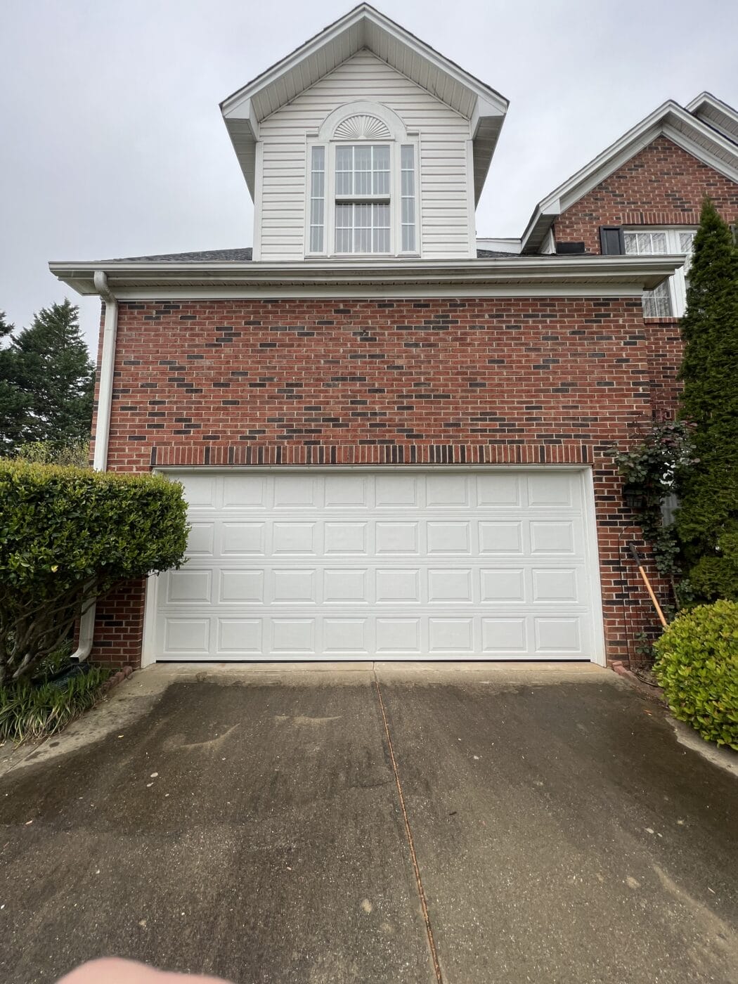 New white garage door on white house