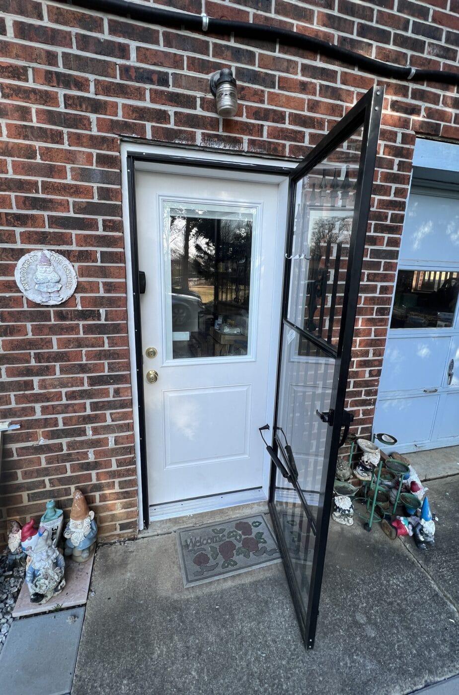 Open storm door on brick home